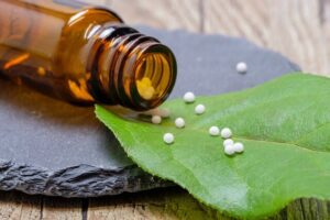 homeopathic pellets on green leaf